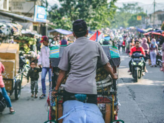 Man rides his cart in Indeonesian streets